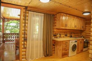 a kitchen in a log cabin with a stove at Rest House in Oni