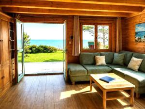 a living room with a couch and a table at Strandhus Mira in Dahme