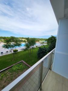 a balcony with a view of a body of water at Sunset Beach Studio by Blaxy Resort Olimp in Olimp