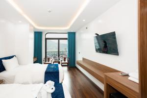 a hotel room with two beds and a balcony at ANH ANH HOTEL in Bắc Hà