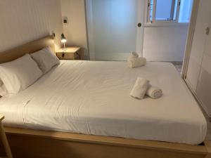 a bed with two towels sitting on top of it at Beachfront Apartment with Sea Views & Private Parking in San Pol de Mar
