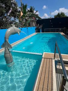 a dolphin water fountain in a swimming pool at LUNA by LCB Apartelle and Resort Tagaytay in Tagaytay