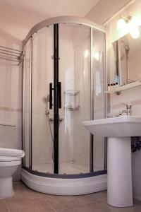 a bathroom with a shower and a sink and a toilet at Bozcaada Su otel in Bozcaada +21 photos
