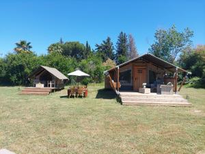 a couple of huts sitting on top of a field at casa la luna glamping in Alhaurín el Grande