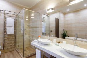 a bathroom with two sinks and a shower at Khatai Center Hotel in Baku