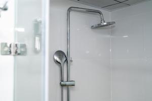 a shower with a shower head in a bathroom at ANH ANH HOTEL in Bắc Hà +105 photos