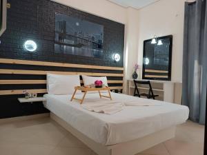 a bedroom with a large bed with a table on it at Local Paradise Xilokastro in Xylokastro +116 photos