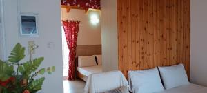 a room with a bedroom with a bed and a couch at Local Paradise Xilokastro in Xylokastro