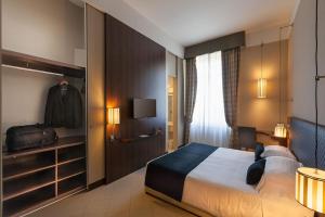 a bedroom with a large bed and a closet at TH Roma - Carpegna Palace in Rome +169 photos