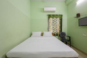 a bedroom with a large white bed in a room at Hotel Sridevi Grand in Vākalapūdi