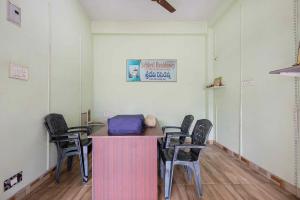 a room with chairs and a table with a bag on it at Hotel Sridevi Grand in Vākalapūdi +24 photos
