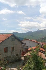 a view of a village with mountains in the background at Piano Piano Affittacamere in Andagna