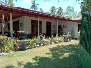a house with a bunch of plants in the yard at Green Gardens in Weligama