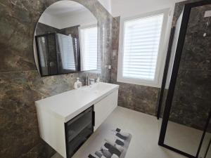 a bathroom with a white sink and a mirror at Aria venice rooms in Tessera +24 photos