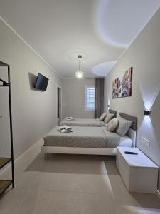 a white bedroom with a bed and a couch at Aria venice rooms in Tessera