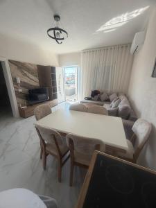 a living room with a table and a couch at Alison Guest House in Durrës