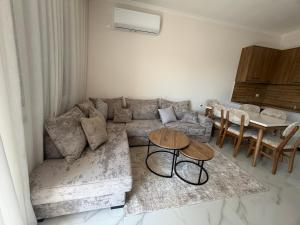 a living room with a couch and a table at Alison Guest House in Durrës