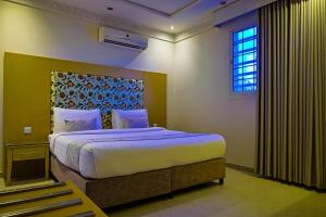 a bedroom with a large bed and a window at Dar NEYAARA SERVICED APARTMENTS - Economic in Riyadh +41 photos
