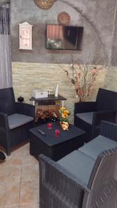 a living room with chairs and a table and a television at LA PETITE MAISON in Fucecchio