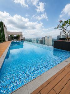 a swimming pool on the roof of a building at Riveria City by Nomadnest in Kuala Lumpur