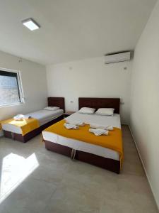 a bedroom with two beds in a room at Villa Utopia in Star Dojran