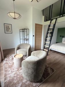 a living room with two chairs and a bed at Sillage in Machiel +28 photos