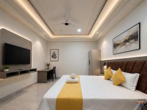 a bedroom with a bed and a tv on the wall at Hotel Shanti Residency Vrindavan in Vrindāvan