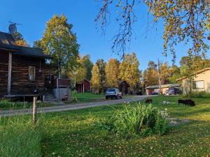 a house and some animals on the side of a road at Hirsipirtti in Inari