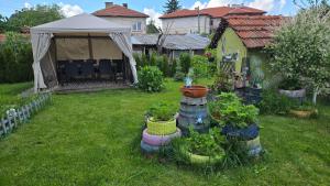 a garden with a tent and some plants in a yard at Nayri HOUSE Самоков,село Доспей in Dospey