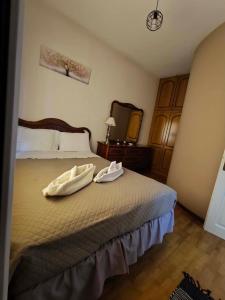 a bedroom with a bed with two towels on it at Kalymnos Sea View Villa in Kalymnos