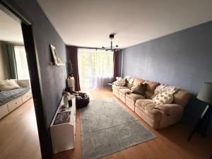 a living room with a couch and a table at Kauguri apartment residence in Jūrmala
