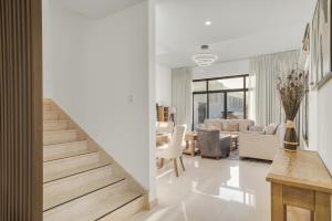 a living room with a staircase and a dining room at 3BR villa BBQ Pool and Maidroom near diving center Dana Island in Sharm