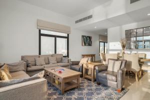 a living room with couches and chairs and a table at 3BR villa BBQ Pool and Maidroom near diving center Dana Island in Sharm +35 photos