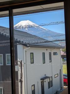 a view of a snow covered mountain from a window at 街のホテル in Fujiyoshida +22 photos