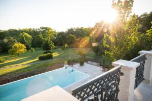 a swimming pool on a balcony with the sun shining at Scharioth Birtok in Nagyréde +6 photos