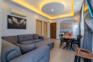 a living room with a couch and a table at Royalis Apart Hotel in Fethiye