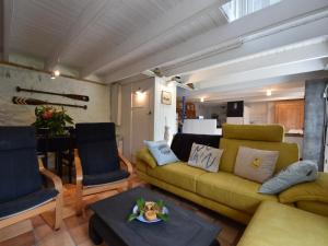 a living room with a yellow couch and a table at Brittany Escape with Garden in Kersaudy +49 photos