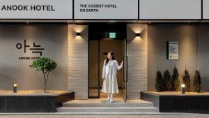 a woman standing in the doorway of a hotel at Anook Hotel Nowon Sanggye in Seoul +101 photos