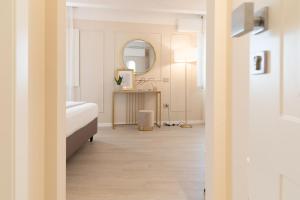a room with a bed and a table with a mirror at Residenza Isotta in Rimini +9 photos