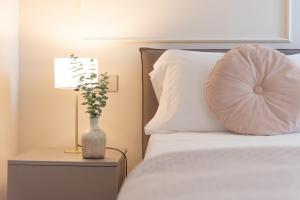a bedroom with a bed with a pillow and a lamp at Residenza Isotta in Rimini