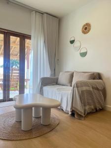 a living room with a coffee table and a couch at Nomad Beach House, Koh Lanta in Ko Lanta +12 photos