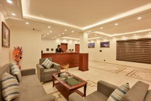 a man standing in a lobby with a waiting room at Hotel Aero Ladakh in Leh