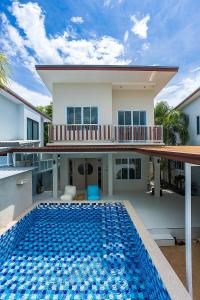 a house with a swimming pool in front of a house at Villa Paradise a unique cocoon in Bophut