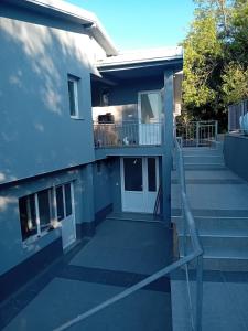 a blue building with a porch and a balcony at Villa Utopia in Star Dojran