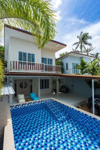 a house with a swimming pool in front of a house at Villa Paradise a unique cocoon in Bophut