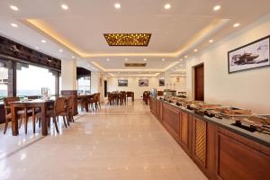 a restaurant with a bar and tables and chairs at Hotel Aero Ladakh in Leh