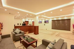 a man standing at a reception desk in a lobby at Hotel Aero Ladakh in Leh +32 photos