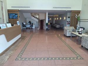 a lobby with chairs and tables in a building at فندق الفال الشمالي الفندقية in Ḑubā