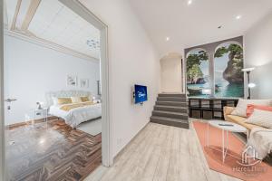 a living room with a couch and a bed at SweetWater Villa - Pool - Solarium - Smart TV in Savona