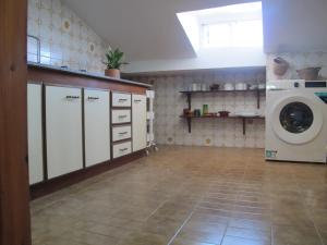 a laundry room with a washer and a washing machine at Ático Yuly in Rianjo